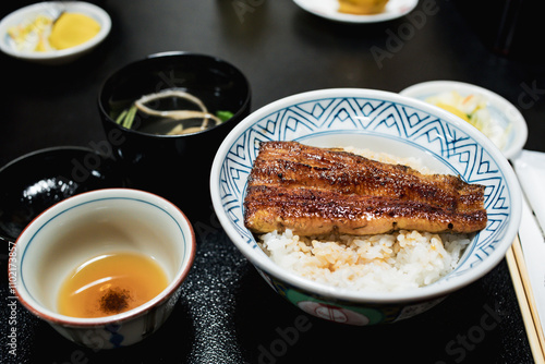 Close up of traditional or local Japanese food - grilled Unagi over rice serve with miso soup, fruit and vegetable. roasted eel cookery. freshness and delicious Japan meals. Juicy food.
