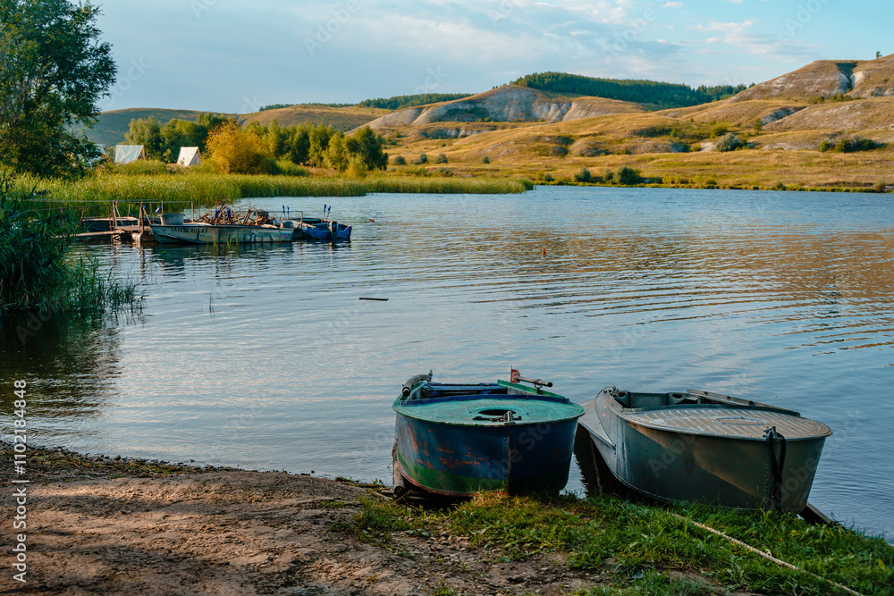 Beautiful rural landscape with mountains and hills and boats on the lake. Beautiful rural landscape with mountains and hills and boats on the lake.