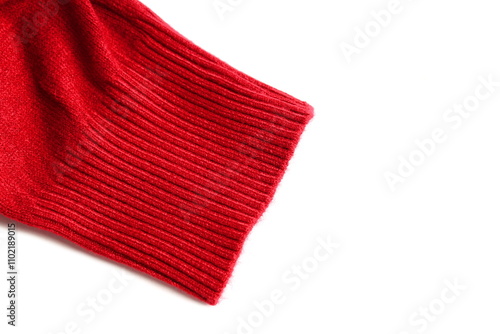 The cuff of the sleeve of a red turtleneck lies on a white background. photo