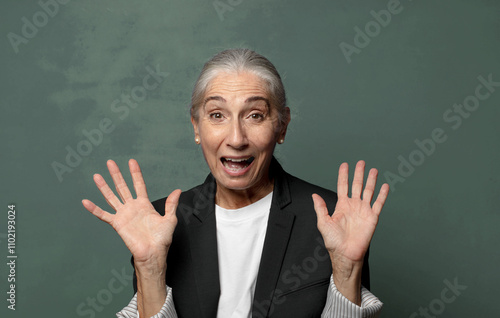  looking happy and excited, shocked with an unexpected surprise with both hands open next to face photo