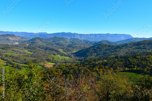 Valley and hills of Kras in Primorska, Slovenia with Nanos mountains behind photo