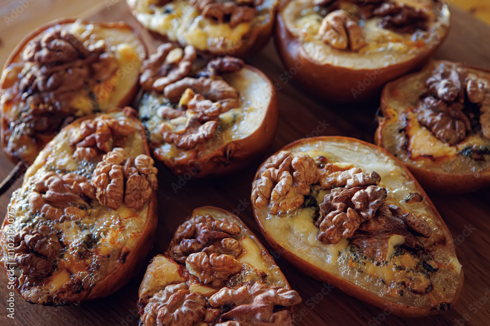 Baked pears topped with walnuts and blue cheese, capturing a rustic and comforting feel Baked pears topped with walnuts and blue cheese, capturing a rustic and comforting feel