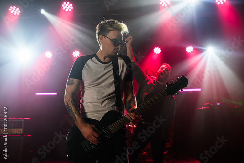 Canvas Print Guitarist performing live on stage with bandmates