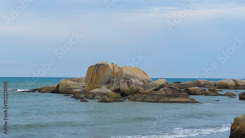 Vast Blue Ocean Sea Surrounding Big Brown Orange Boulder Rocks