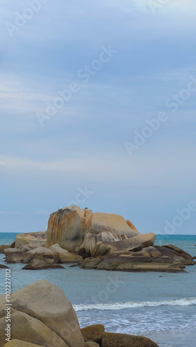 Vast Blue Ocean Sea Surrounding Big Brown Orange Boulder Rocks