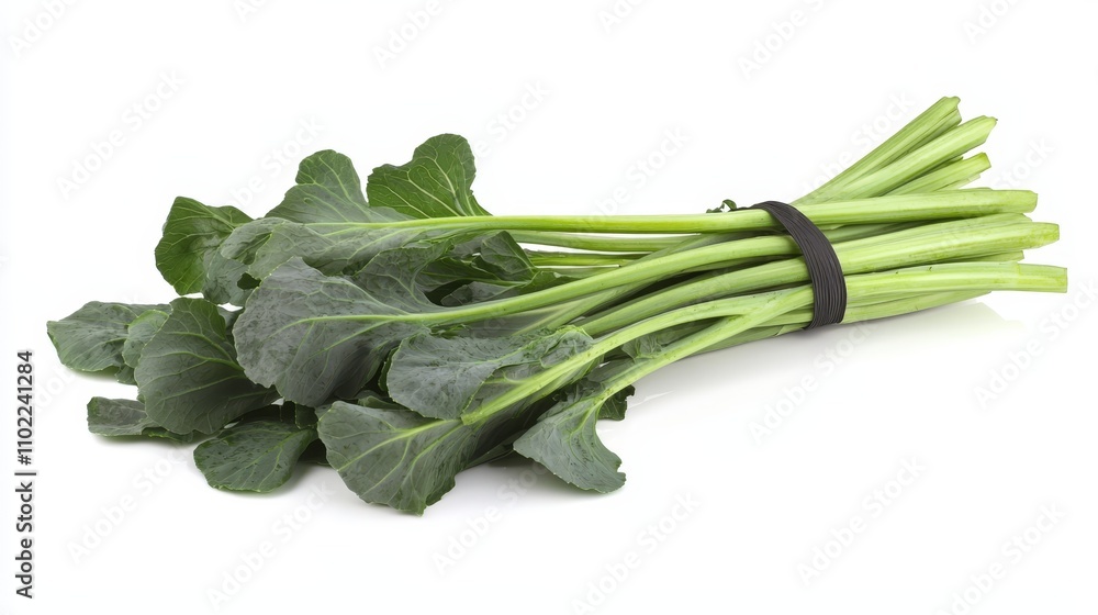 a bunch of green collard greens tied together with a black ribbon on a white background a bunch of green collard greens tied together with a black ribbon on a white background
