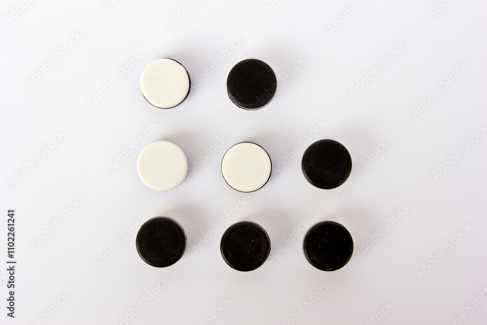 Black and white board game pieces isolated on white background. Black and white board game pieces isolated on white background.