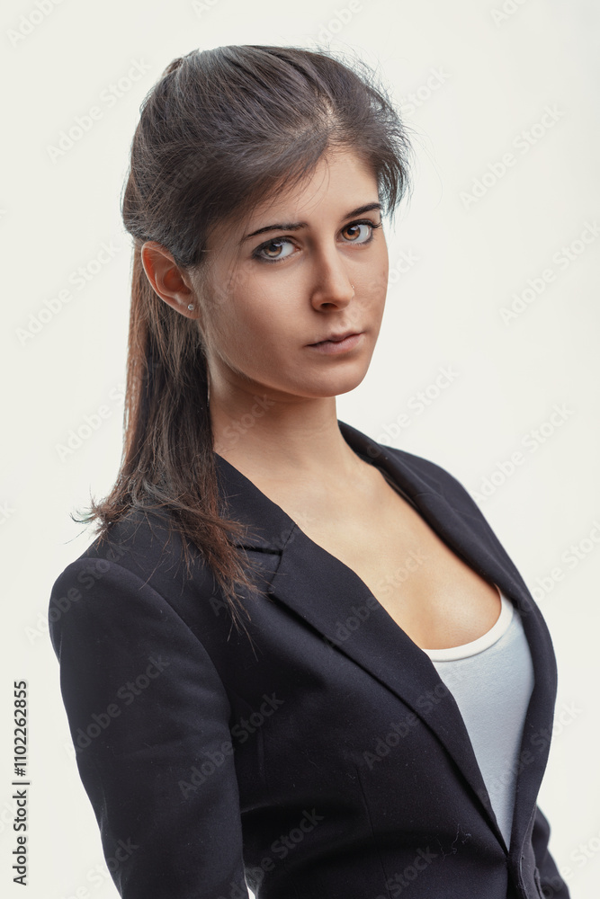 Fototapeta premium Serious young businesswoman looking at the camera