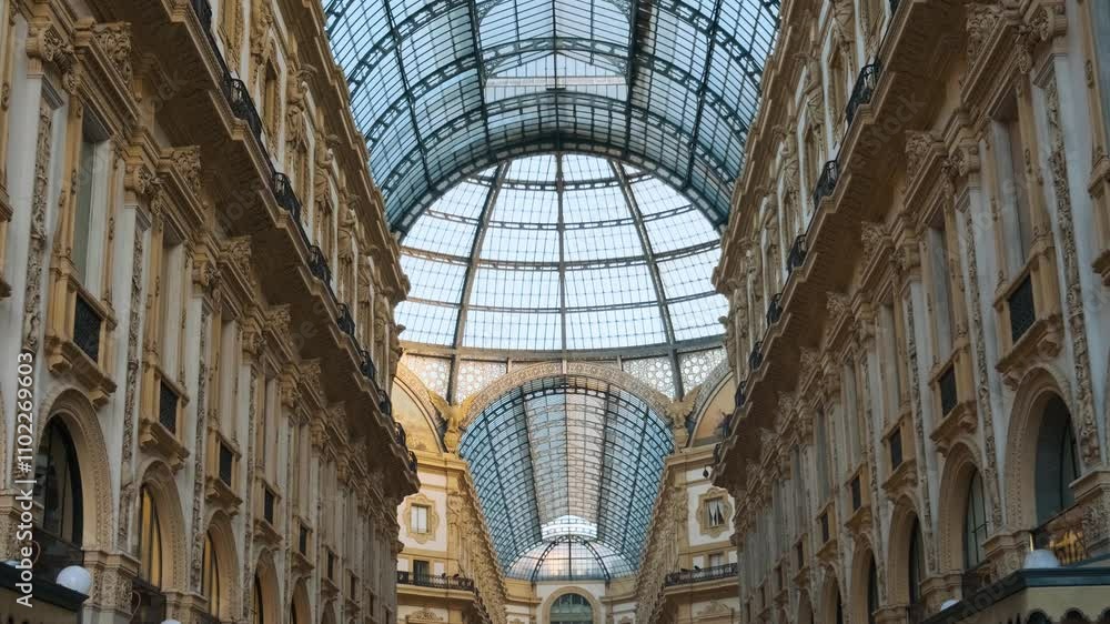 Interior of Galleria Vittorio Emanuele II in Milan, Italy. Oldest Italian shopping mall neoclassical architecture with grand glass dome and decorative details in Milano city Interior of Galleria Vittorio Emanuele II in Milan, Italy. Oldest Italian shopping mall neoclassical architecture with grand glass dome and decorative details in Milano city