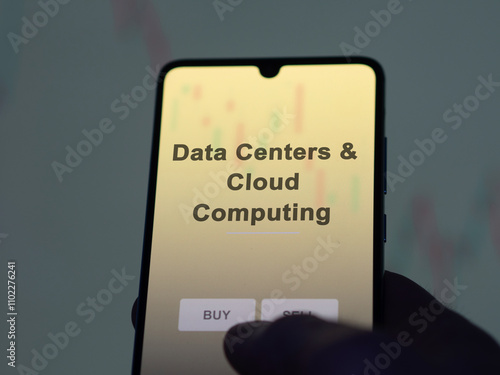 An investor analyzing the data centers & cloud computing etf fund on a screen. A phone shows the prices of Data Centers & Cloud Computing photo