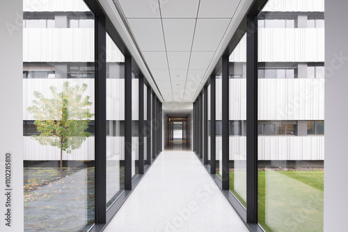 Modern hospital corridor with large glass windows photo