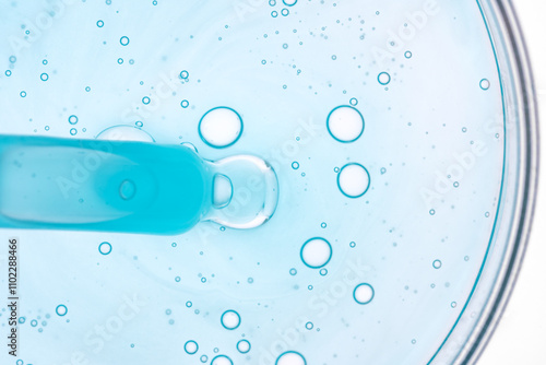 Blue Liquid with Bubbles in Petri Dish Captures Microscopic View