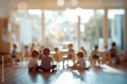 Blurred view of a modern playroom of kindergarten school with kids sitting playing together