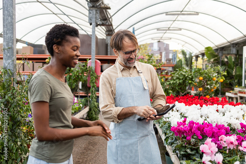 Friendly interaction in a vibrant garden store setting photo