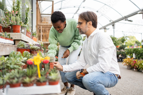 Exploring diverse plants in a greenhouse garden center