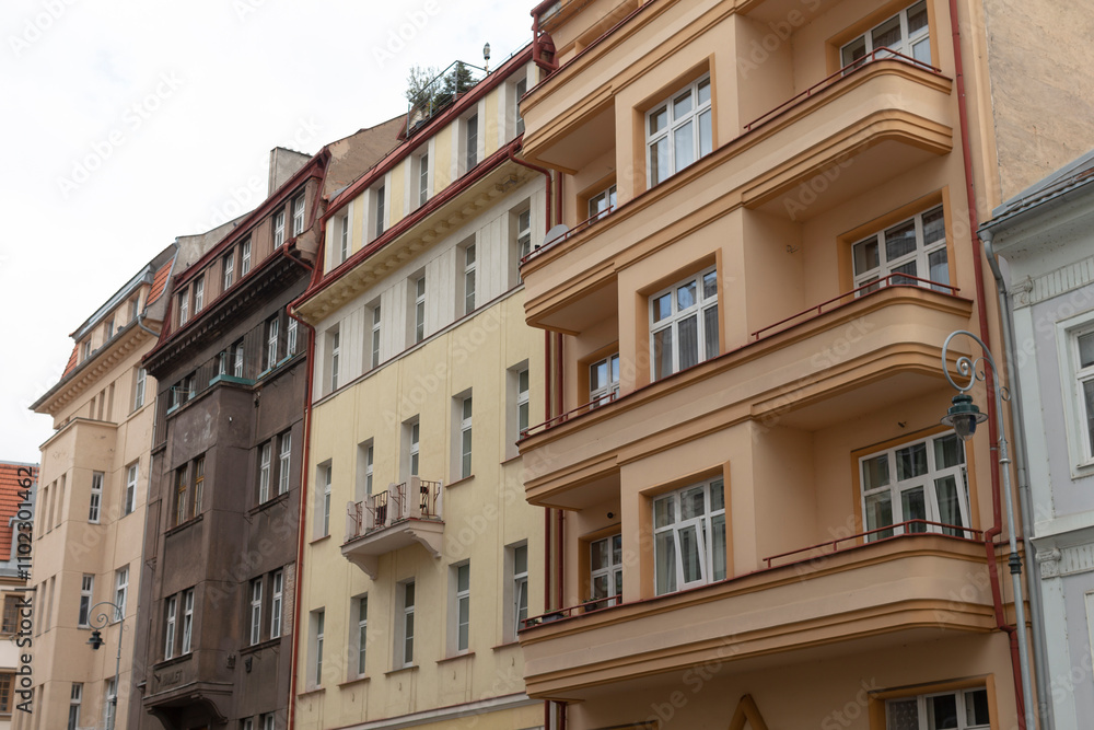 Obraz premium A long and beautiful row of buildings featuring attractive balconies positioned along the side of each structure, enhancing their aesthetic appeal