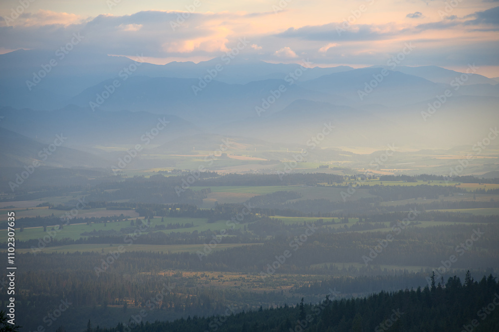Misty mountain valley with layers of hills during sunset. Misty mountain valley with layers of hills during sunset.