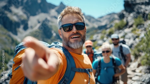 Two hikers in bright clothing actively navigate rocky terrain surrounded by imposing mountains, embodying adventure and connection to the outdoors on a sunny day. photo