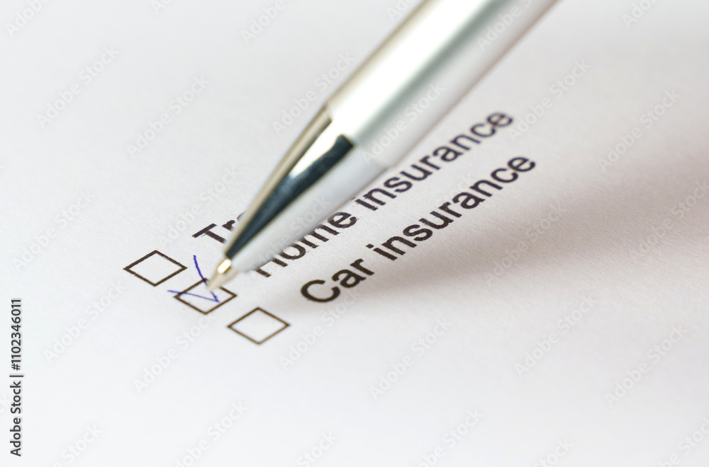 Fototapeta premium Checking off insurance options on a printed checklist with a pen