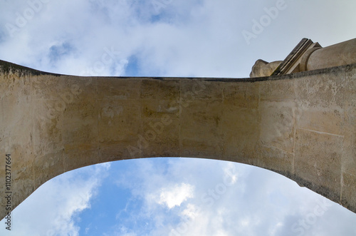 building, arch bridge with blue sky above it