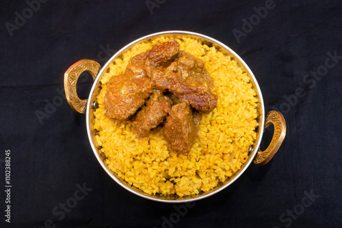 beef khuchuri rice served in karahi isolated on wooden table top view of bangladeshi food photo