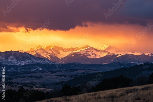 Mountains stretch across the horizon, bathed in an otherworldly golden light, symbolizing serenity and the eternal beauty of natural landscapes captured at dusk. photo