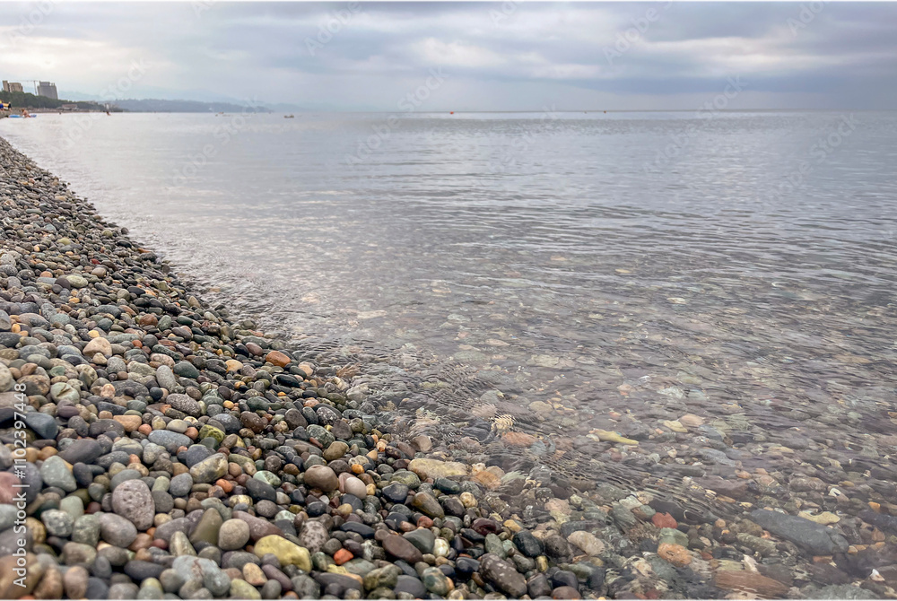 the sea wave rolls over the colorful pebbles on the Black Sea coast the sea wave rolls over the colorful pebbles on the Black Sea coast