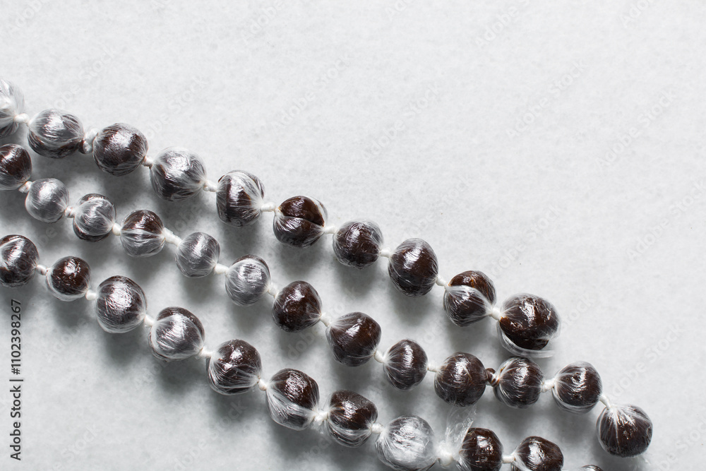 Overhead view of nigerian baba dudu candy on white background, top view of Ghana coconut candy or kube toffee candy, hard candy made with coconut milk and sugar on granite countertop Overhead view of nigerian baba dudu candy on white background, top view of Ghana coconut candy or kube toffee candy, hard candy made with coconut milk and sugar on granite countertop