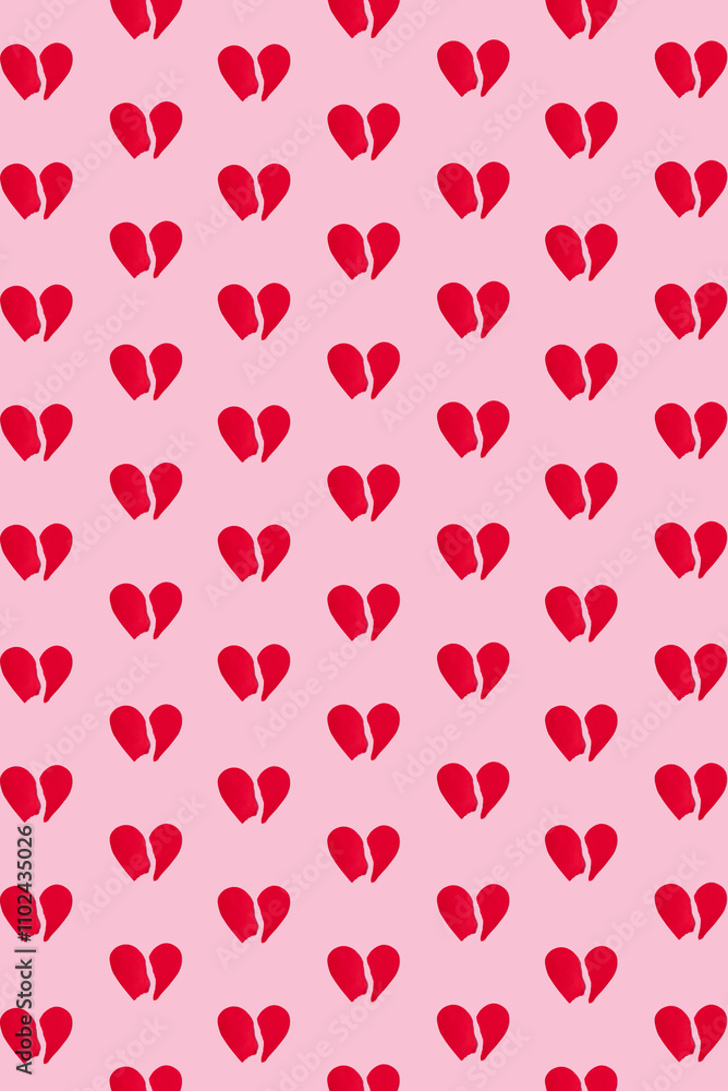 Pattern of red paper heart torn into two halves on pastel pink background. Broken heart concept, top view Pattern of red paper heart torn into two halves on pastel pink background. Broken heart concept, top view