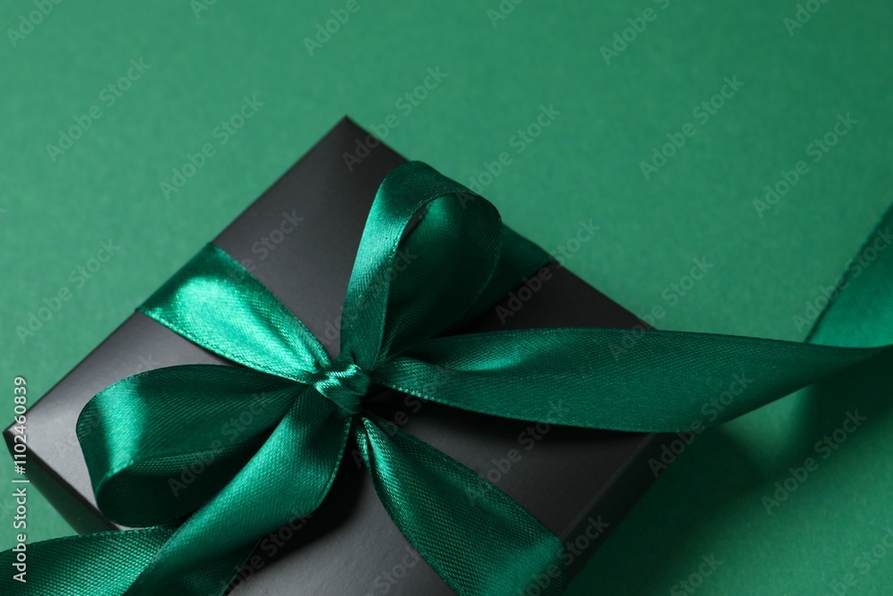 Beautiful gift box tied with bow on color background Beautiful gift box tied with bow on color background
