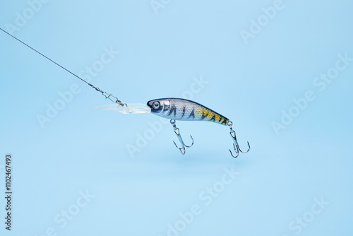 Bild auf Leinwand Fishing bait wobbler jig isolated on the bright blue fond background