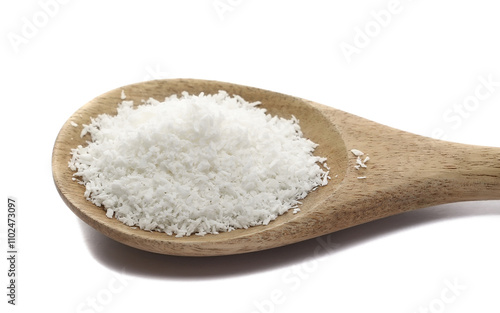 Pile grated coconut in wooden spoon isolated on white, side view 