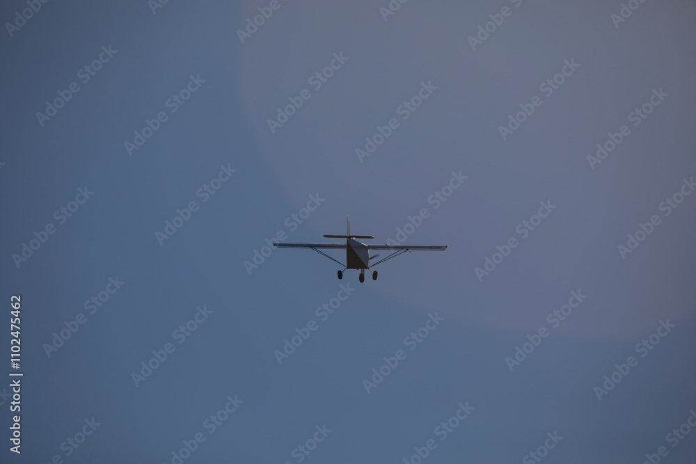 A small plane flies over the Fervenza reservoir in Dumbria with a blue sky A small plane flies over the Fervenza reservoir in Dumbria with a blue sky