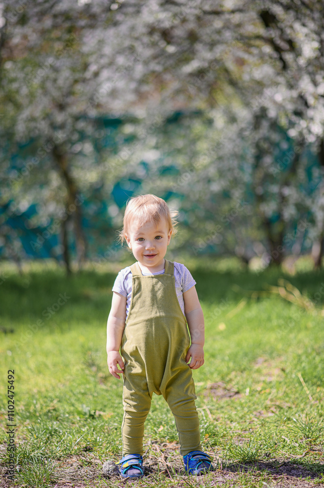 Happy Toddler Playing Outdoors in a Spring Garden Happy Toddler Playing Outdoors in a Spring Garden