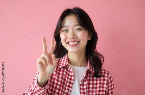 Korean girl on pink background smiling