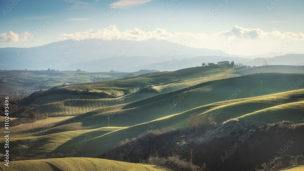 Landscape in Tuscany with farmhouse and rolling hills on a winter afternoon Landscape in Tuscany with farmhouse and rolling hills on a winter afternoon