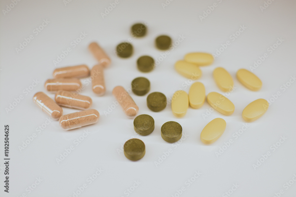 Multi-colored tablets of different shapes with different medical effects on a white background Multi-colored tablets of different shapes with different medical effects on a white background
