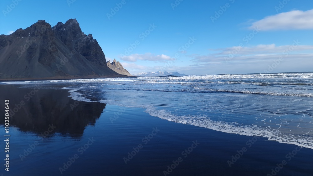 Huge vestrahorn mountains and polar ocean, beautiful nordic setting with natural black sand beach. Icelandic stokksnes peninsula with rocky cliffs and breathtaking wilderness nature. Huge vestrahorn mountains and polar ocean, beautiful nordic setting with natural black sand beach. Icelandic stokksnes peninsula with rocky cliffs and breathtaking wilderness nature.