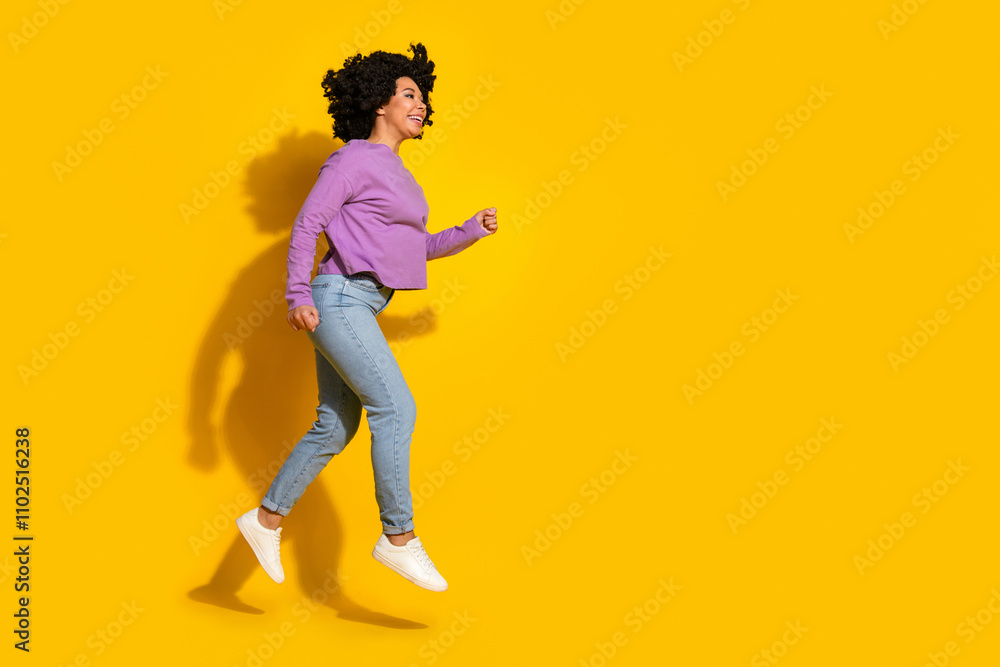 Full length photo of pretty young woman run jump empty space isolated on yellow color background Full length photo of pretty young woman run jump empty space isolated on yellow color background