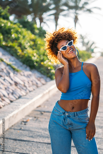 Beautiful black woman posing and sticking out tongue outdoors