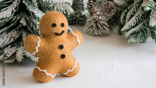 A fluffy, golden gingerbread man, crafted using needle felting technique and has soft and rounded shape, fastive background. photo