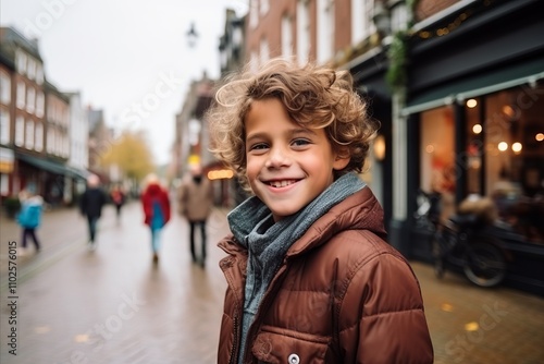 Portrait of a cute little boy with curly hair in the city