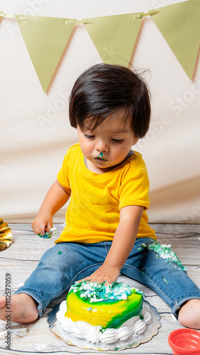 Curious toddler enjoying first birthday cake moment