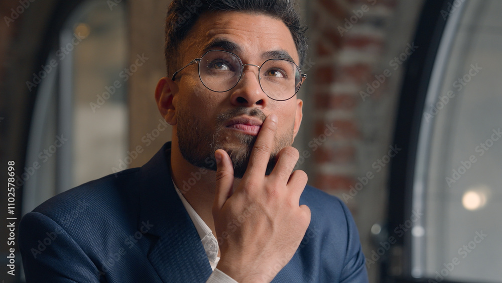 © Yuliia - Thoughtful puzzled businessman Arabian Indian man thinking male guy employer worker think idea business plan strategy ponder consider doubt choose remember decide search deep thought question indoors