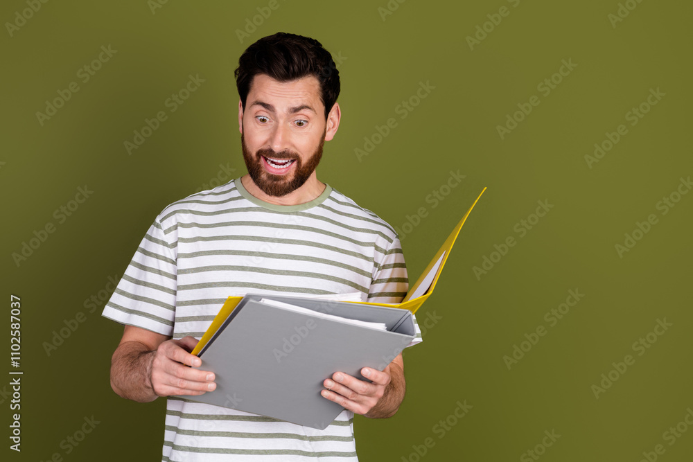 Photo of handsome successful man wear stylish clothes read folders isolated on khaki color background Photo of handsome successful man wear stylish clothes read folders isolated on khaki color background