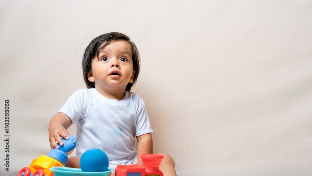 Toddler glancing up while playing with toys Toddler glancing up while playing with toys