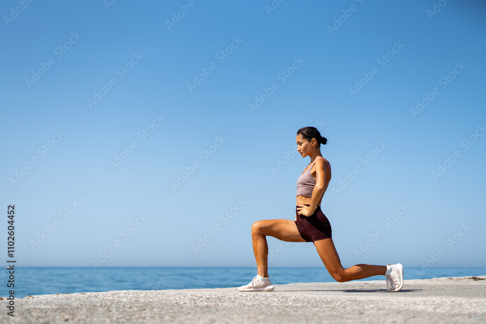 Fit Woman Exercising with Lunges by the Ocean Fit Woman Exercising with Lunges by the Ocean