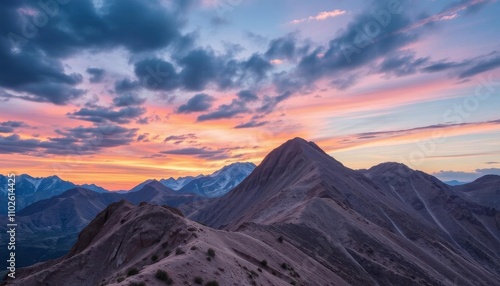 a sunset view of the mountains and clouds from the top of a mountain