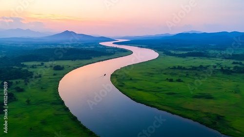 A breathtaking aerial view of a winding river surrounded by lush green hills, showcasing a serene landscape during sunset. The sky is painted in hues of orange and purple, reflecting off the 