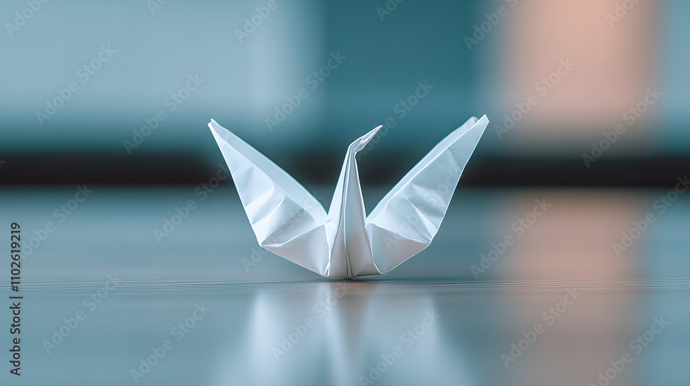 Elegant white paper crane resting on a smooth surface in a serene indoor space during daylight Elegant white paper crane resting on a smooth surface in a serene indoor space during daylight
